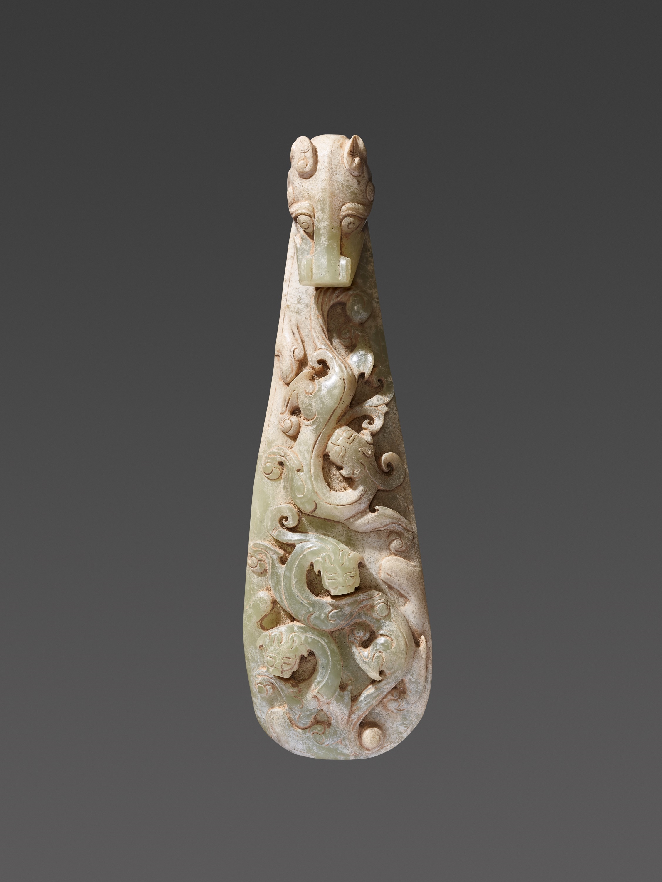 A LARGE ARCHAISTIC CELADON JADE ‘CHILONG’ BELT HOOK by Han Dynasty, 20th century