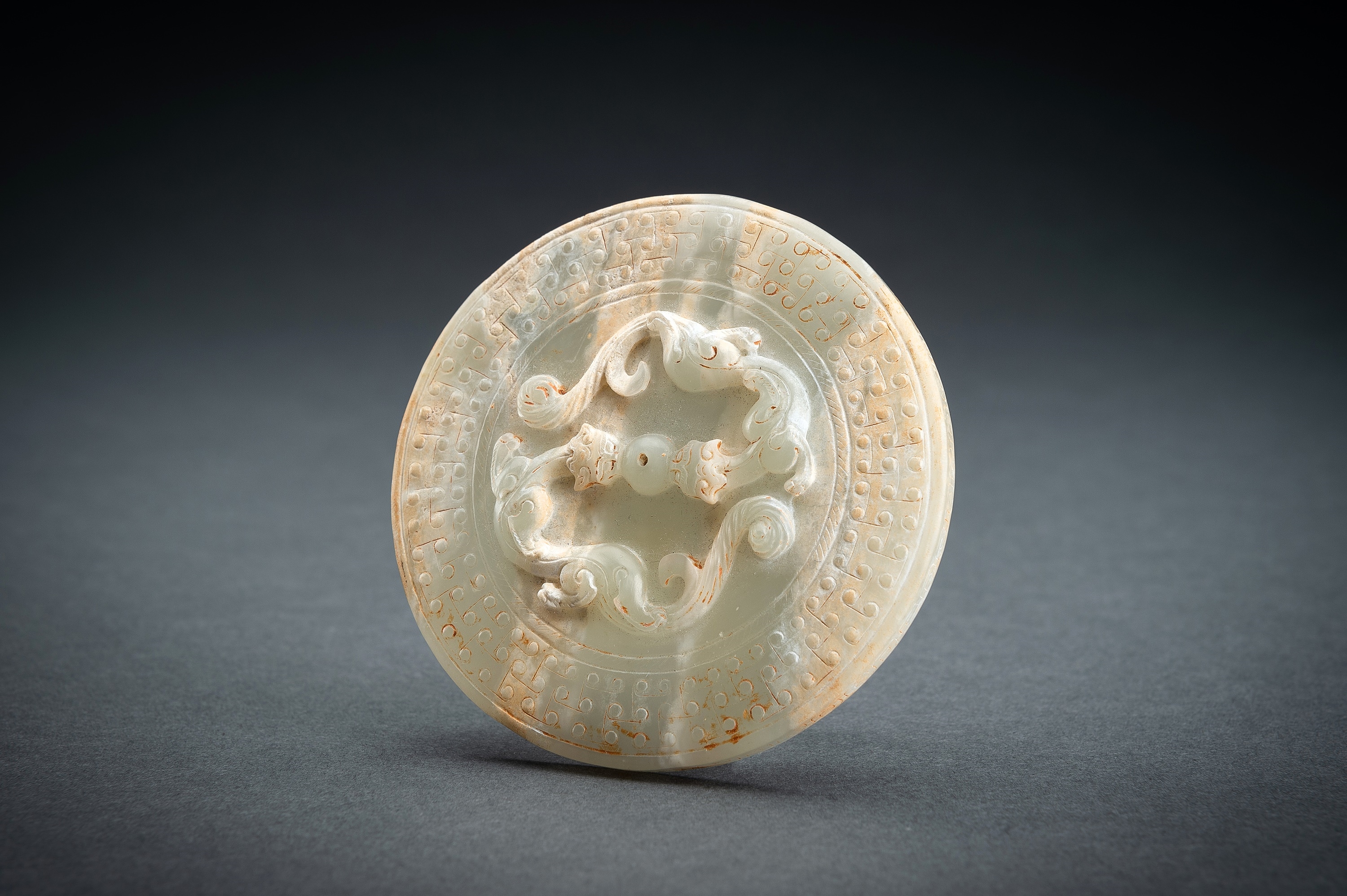 AN ARCHAISTIC PALE CELADON JADE ‘CHILONG’ BOX AND COVER by Han Dynasty, 20th century