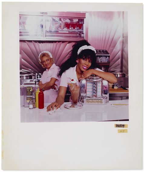 A vintage-style diner scene featuring two figures in pink uniforms behind a counter with a milkshake and jukebox.