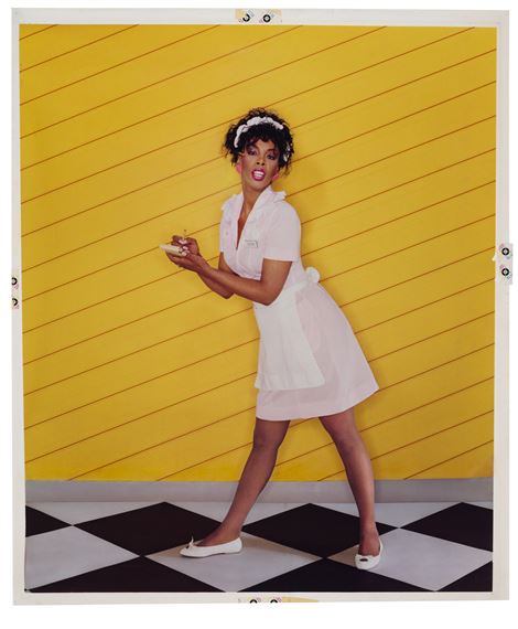 A stylized figure in a white dress poses dynamically against a bold yellow background.