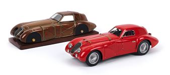 A display of two vintage-style diecast cars, one red and one brown, set against a plain white background.