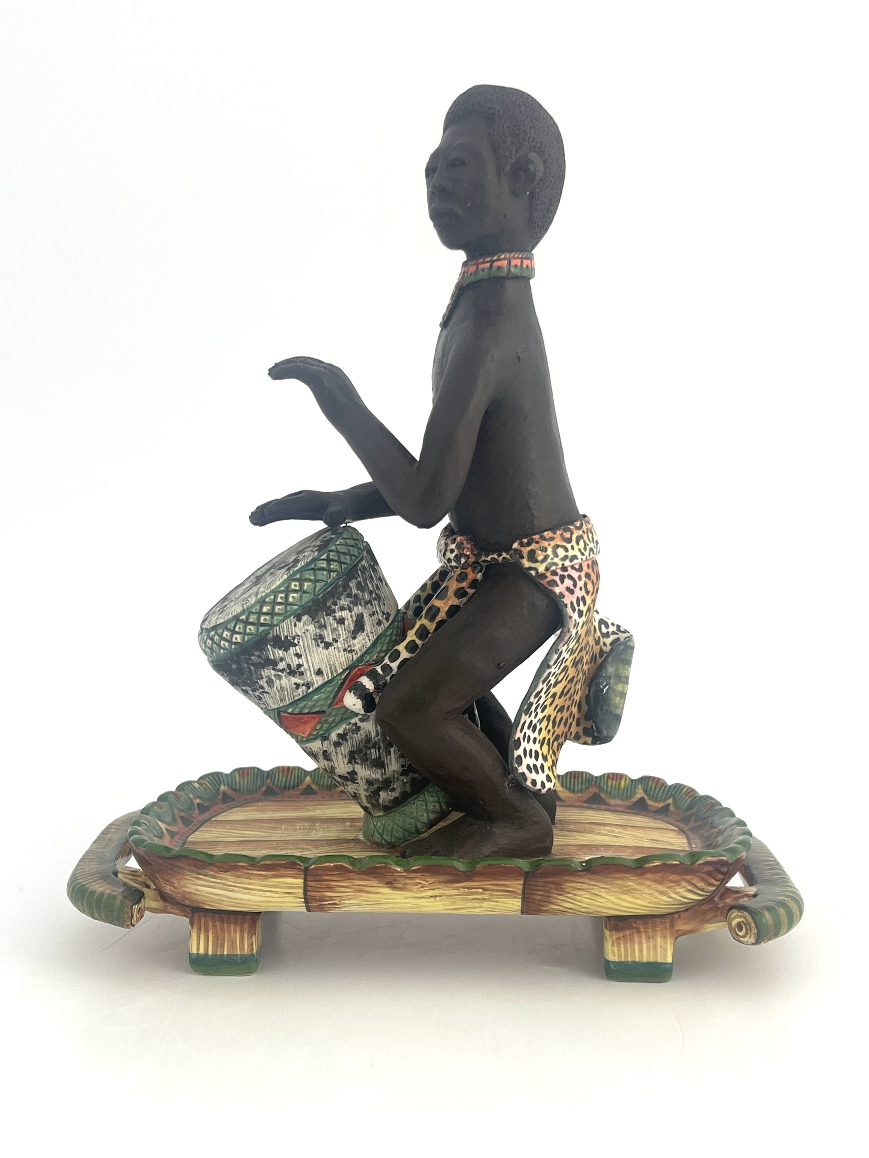 Artwork by Petros Gumbi, Man playing bongo drum, Made of studio pottery