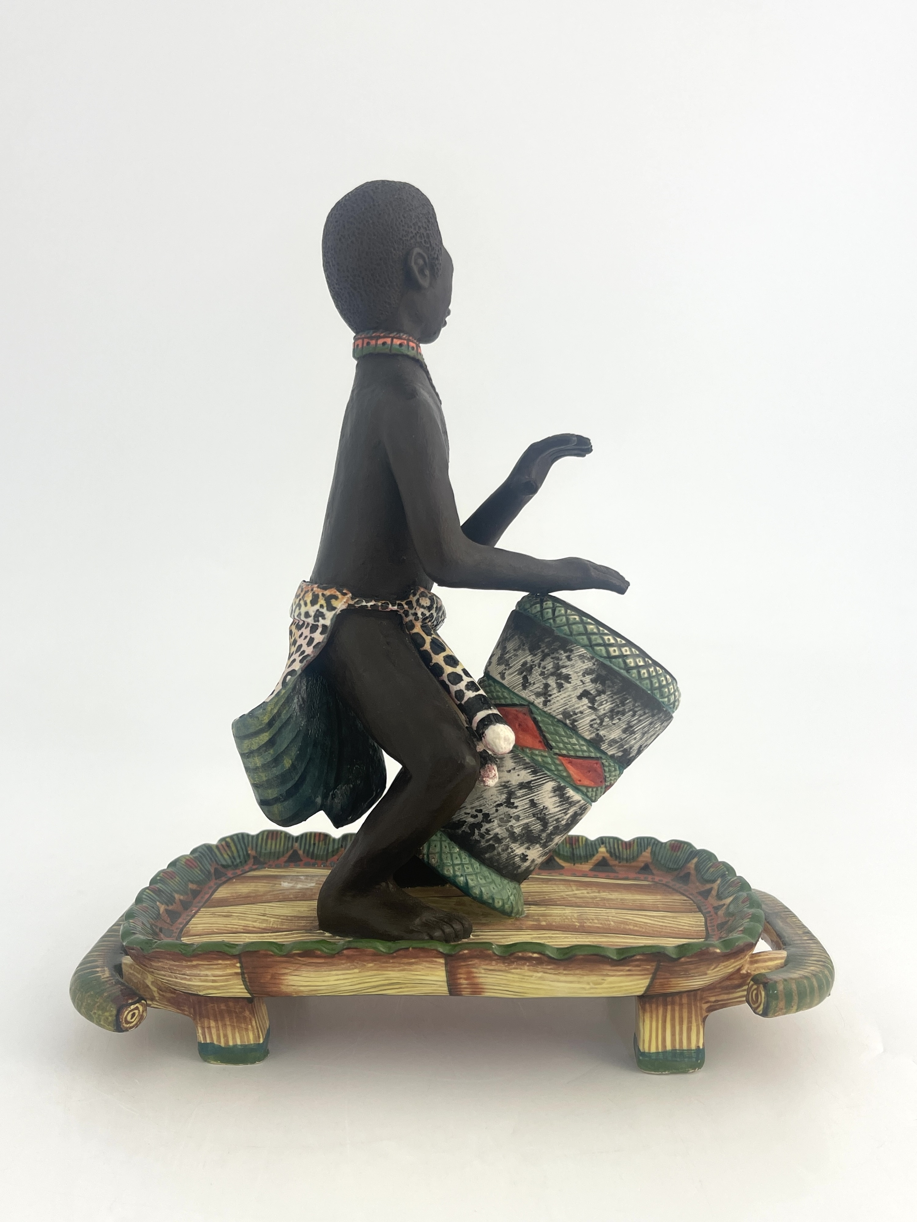 Artwork by Petros Gumbi, Man playing bongo drum, Made of studio pottery