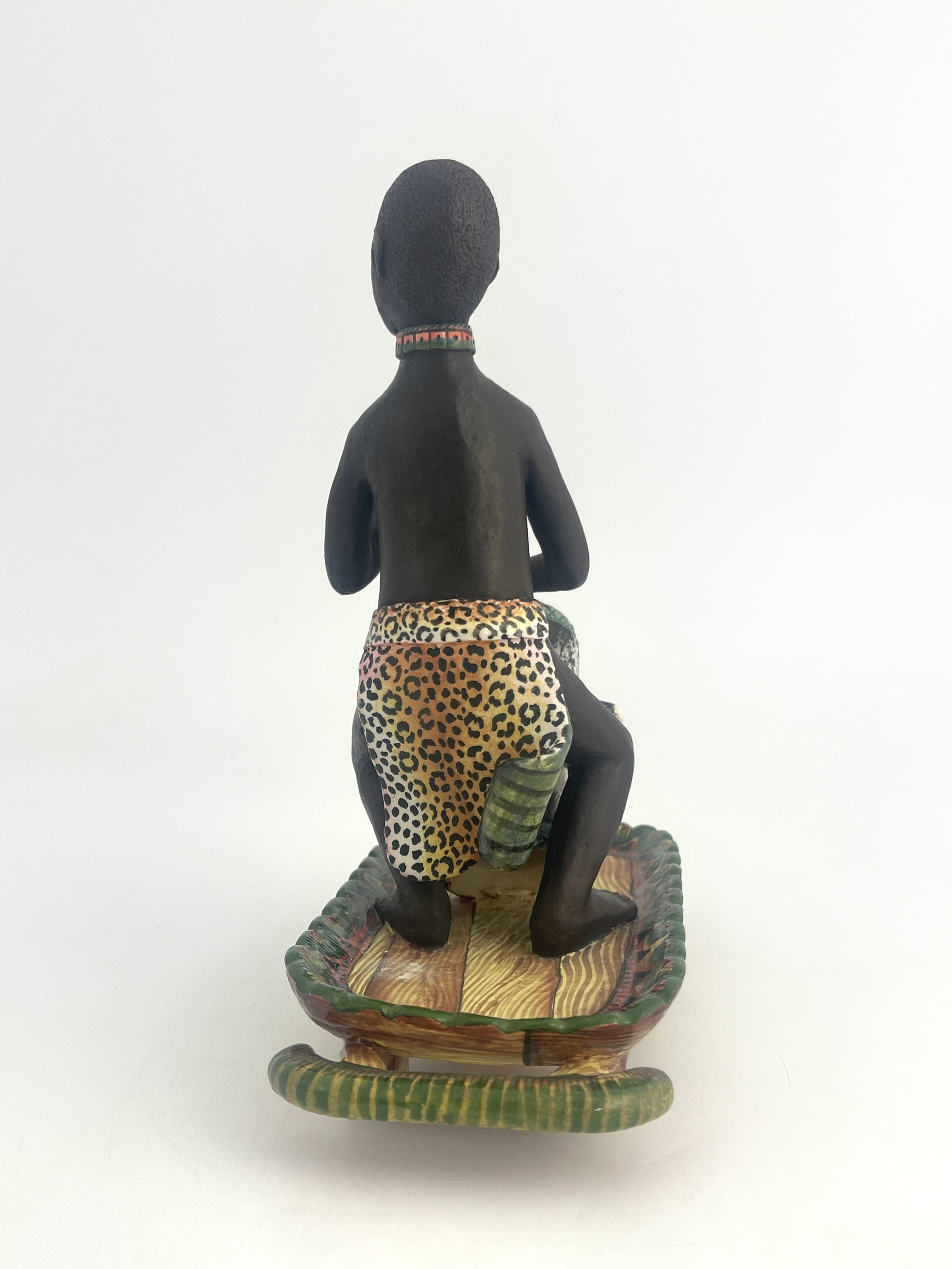 Artwork by Petros Gumbi, Man playing bongo drum, Made of studio pottery