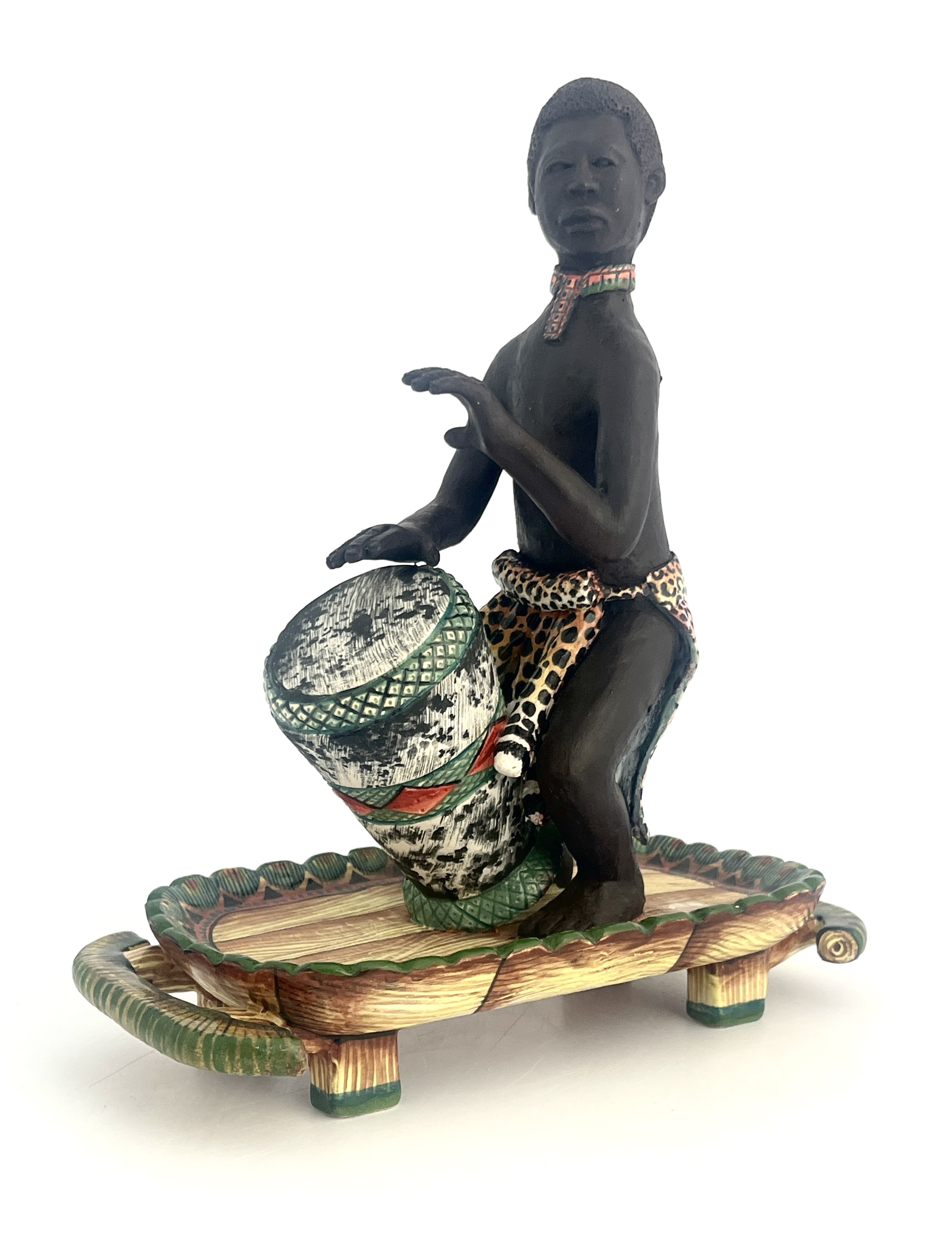 Artwork by Petros Gumbi, Man playing bongo drum, Made of studio pottery