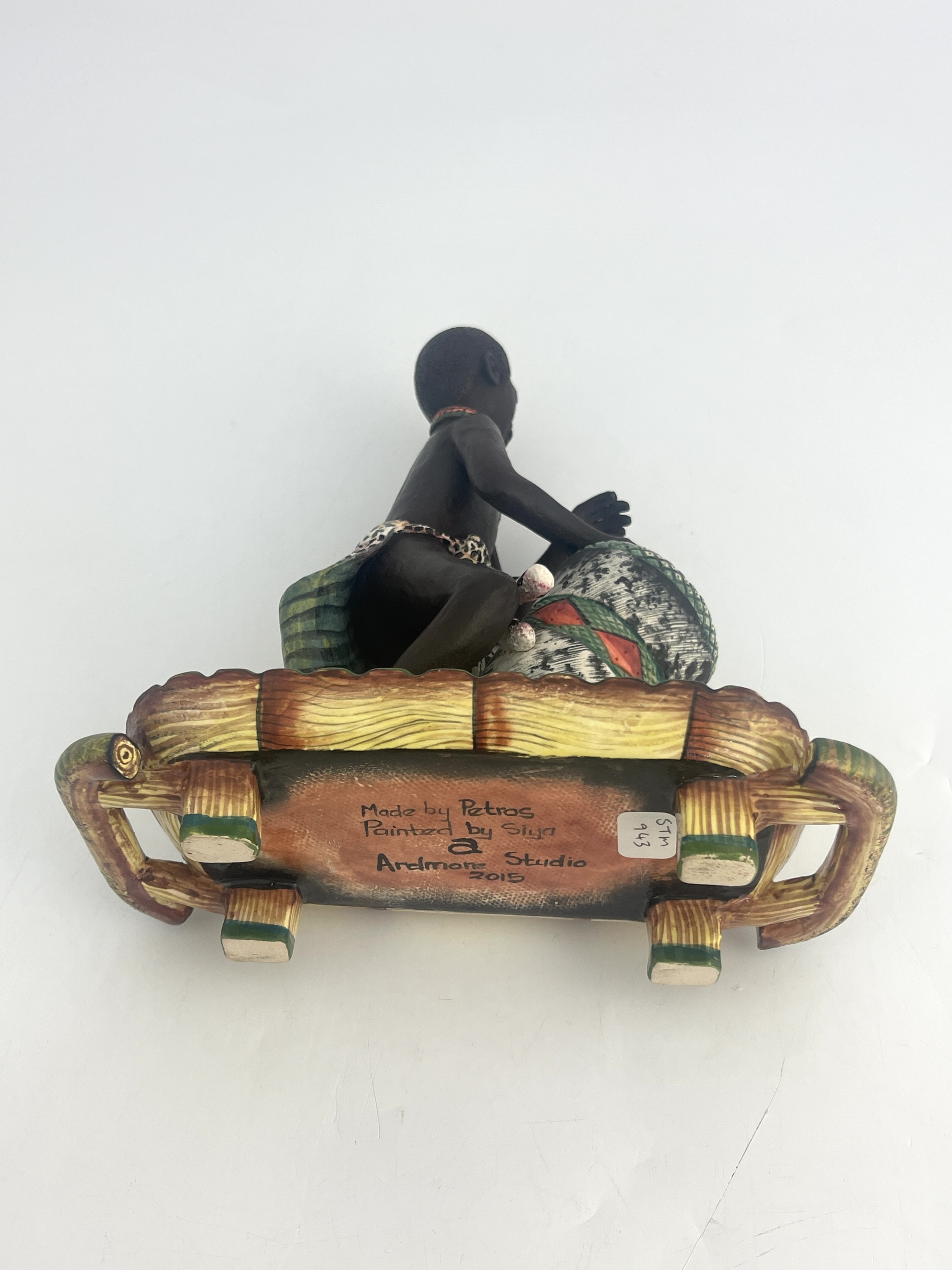 Artwork by Petros Gumbi, Man playing bongo drum, Made of studio pottery