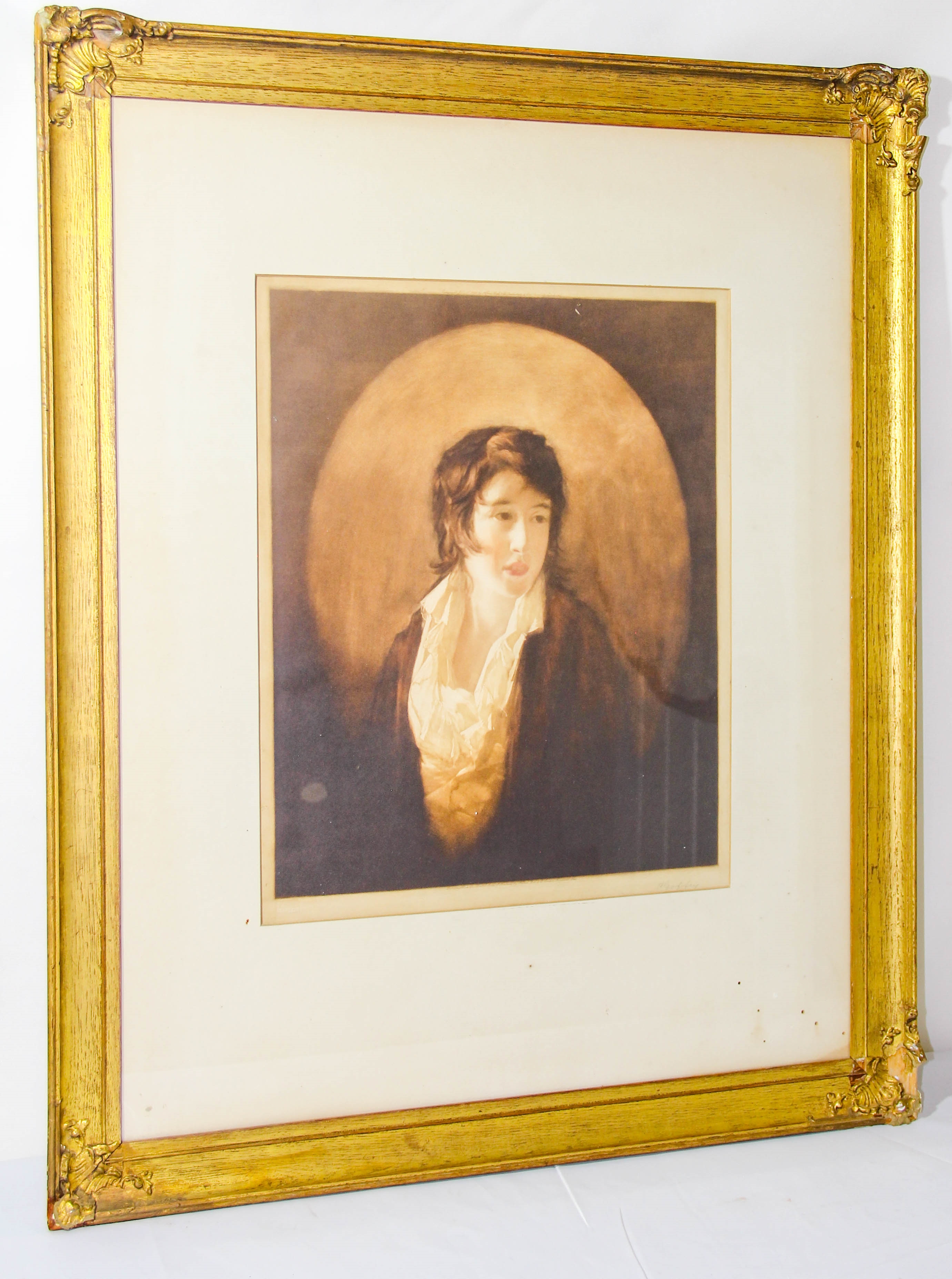 A framed portrait of a person with a golden halo against a dark background.