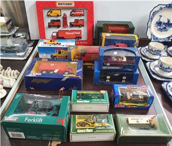 A colorful assortment of boxed toy vehicles and collectibles displayed on a surface.