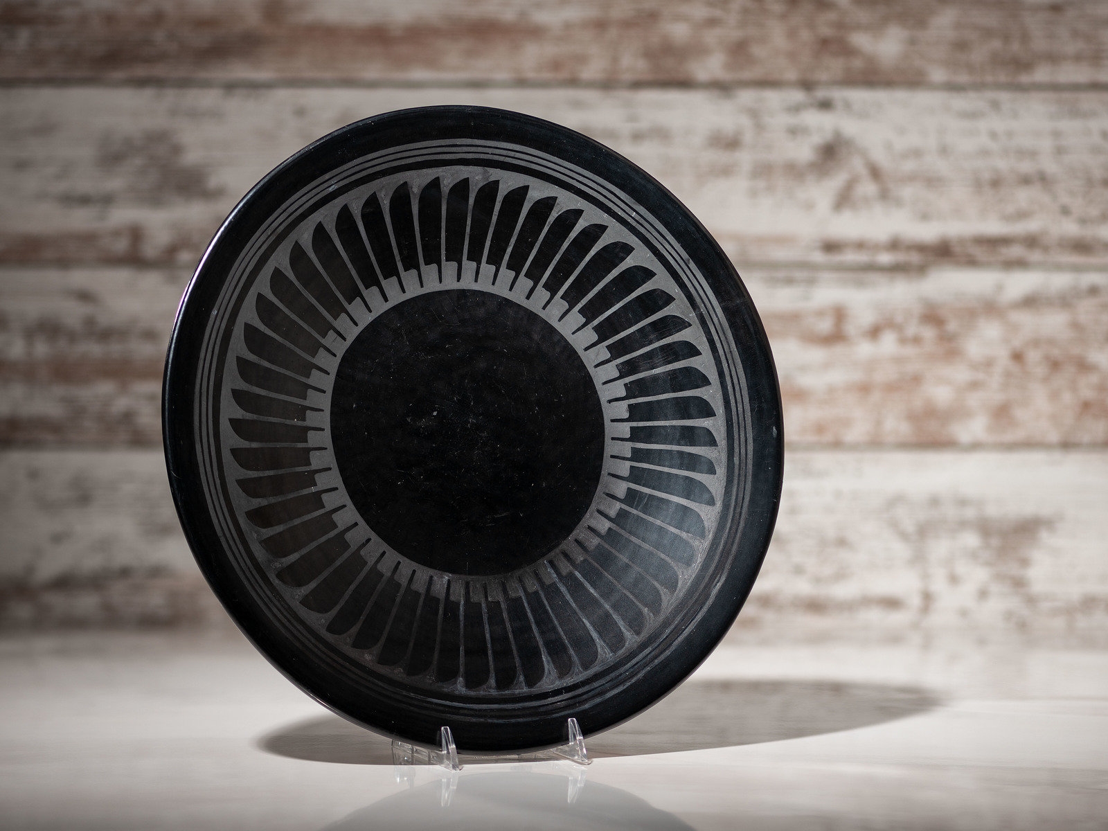 Artwork by Maria Montoya Martinez, Santana Roybal Martinez, Plate with Repeating Feathers, Made of Blackware Pottery