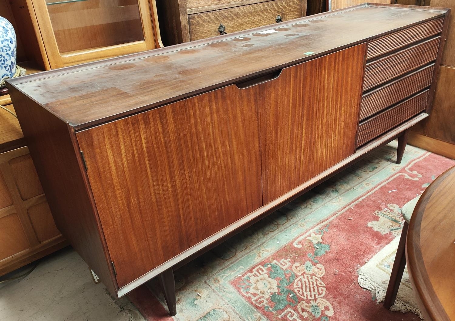 A mid 20th century Richard Hornby for Heals designed teak long low sideboard with four drawers by Richard Hornby, mid 20th century