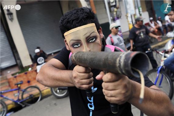 Inti Ocon | Masked protester pointing a homemade mortar during a ...