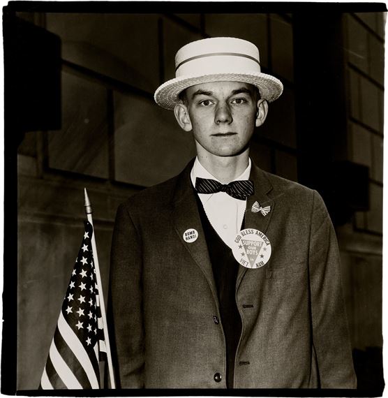 Boy with a straw hat waiting to march in a pro-war parade, N.Y.C. by Diane Arbus, 1967