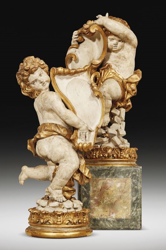 Artwork by Giacomo Serpotta, A pair of sculptures portraying holding-emblem putti, Made of lacquered and gilt wood on circular wood