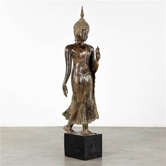 An antique figurine of a 'Walking Buddha', patinated bronze by Thai School, 19th Century, 19th century