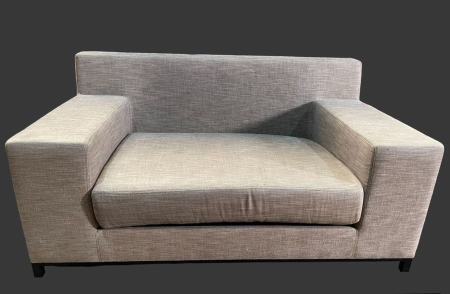 Artwork by Christian Liaigre, Two-seater sofa and comfortable armchair, Made of upholstered in gray fabric