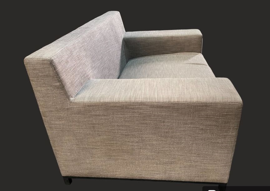 Artwork by Christian Liaigre, Two-seater sofa and comfortable armchair, Made of upholstered in gray fabric