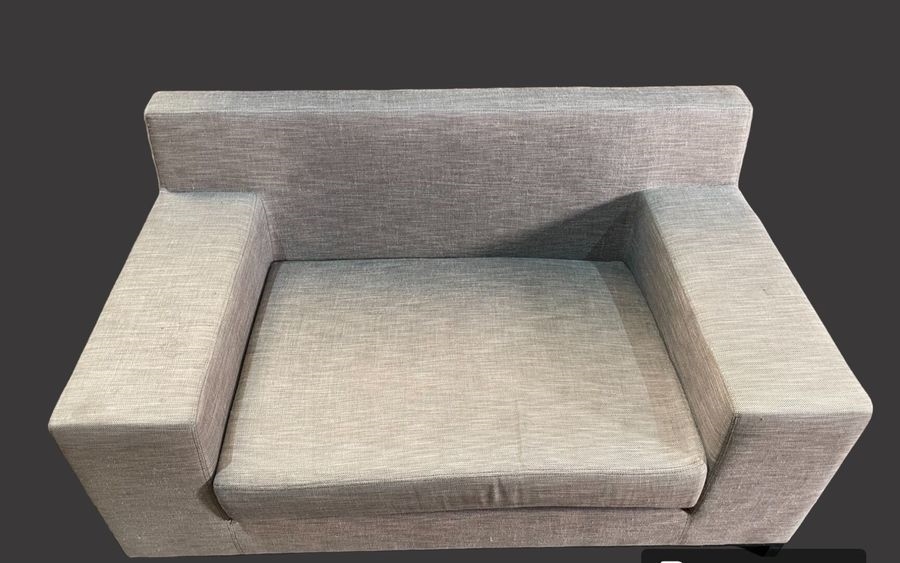 Artwork by Christian Liaigre, Two-seater sofa and comfortable armchair, Made of upholstered in gray fabric