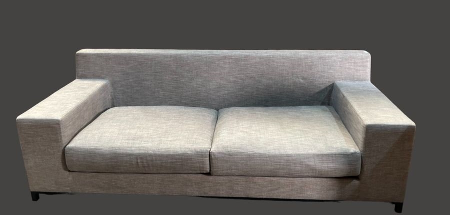 Artwork by Christian Liaigre, Two-seater sofa and comfortable armchair, Made of upholstered in gray fabric