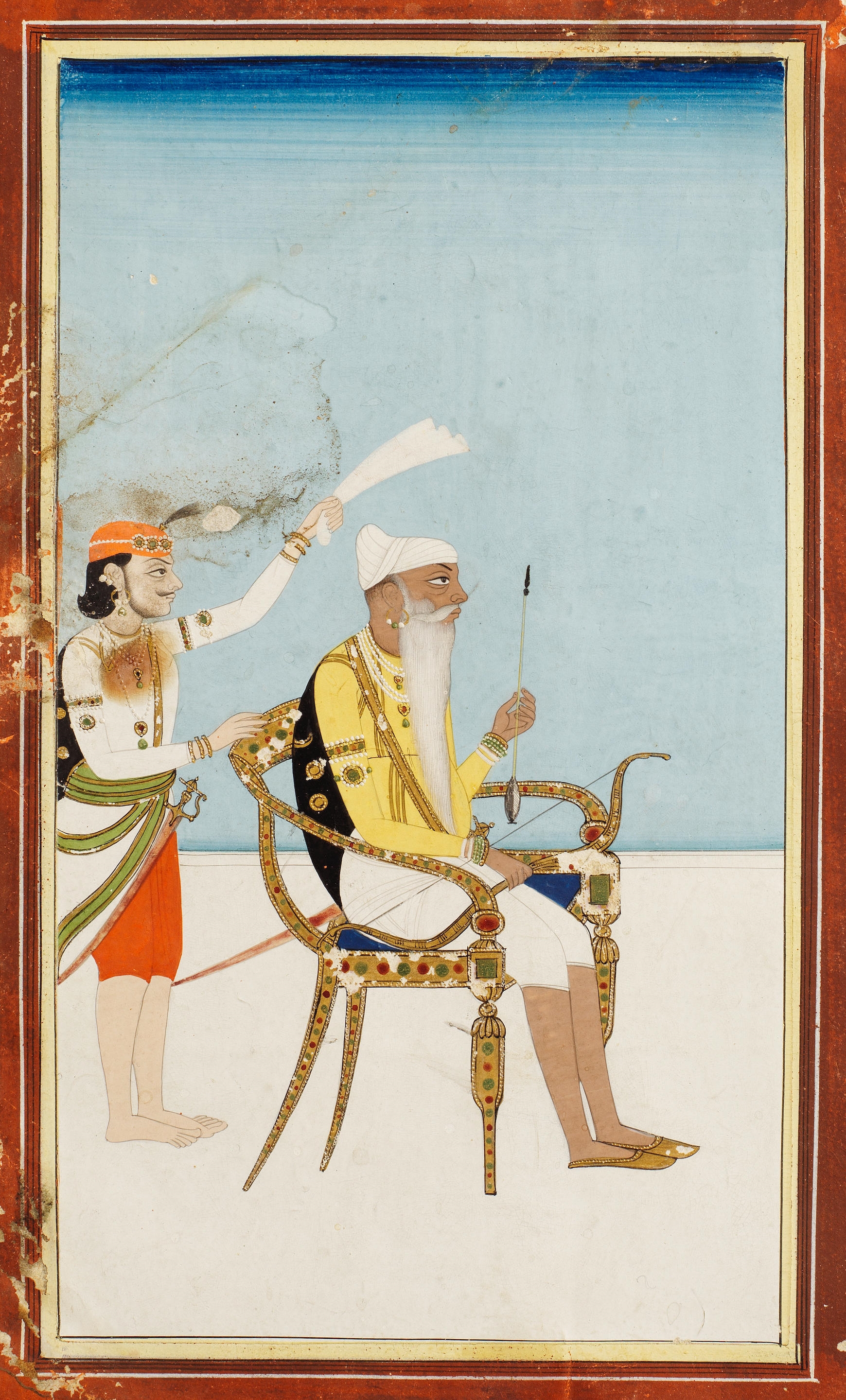 Maharajah Ranjit Singh, holding a bow and an arrow, seated in a chair on a palace terrace, an attendant standing behind him by Punjab School, 19th Century