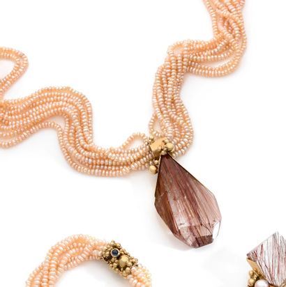 Jean VENDOME (1930-2017)
Necklace of eight strands of freshwater pearls holding a pear-shaped block of rutilated quartz under yellow gold beads. 1994
Signed and hallmarked Weight 118 g by Jean Vendome, 1994