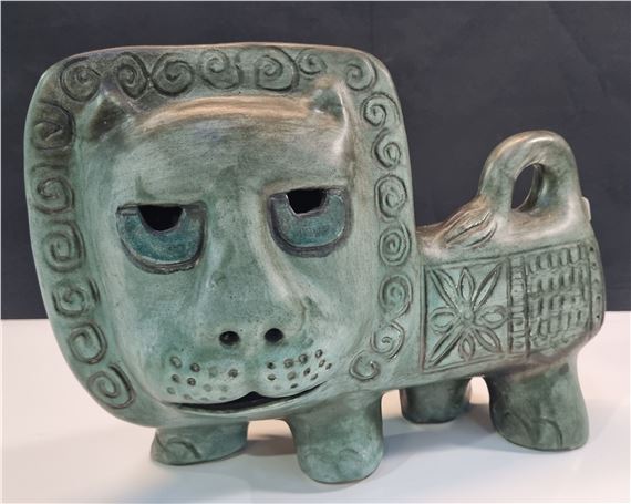 a pottery figure of a lion with celadon glaze by Gus McLaren, 1990