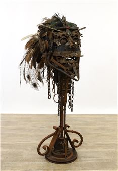 a monumental abstract bust crafted from various tools and machine parts with a peacock feathered head dress - Eric Singer