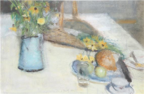 A soft-focus still life of a blue pitcher with flowers, a basket, and a plate of fruit on a white tablecloth.