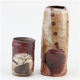 a cylindrical stoneware vase covered in oatmeal glaze with copper red and incised decoration - Adam Frew