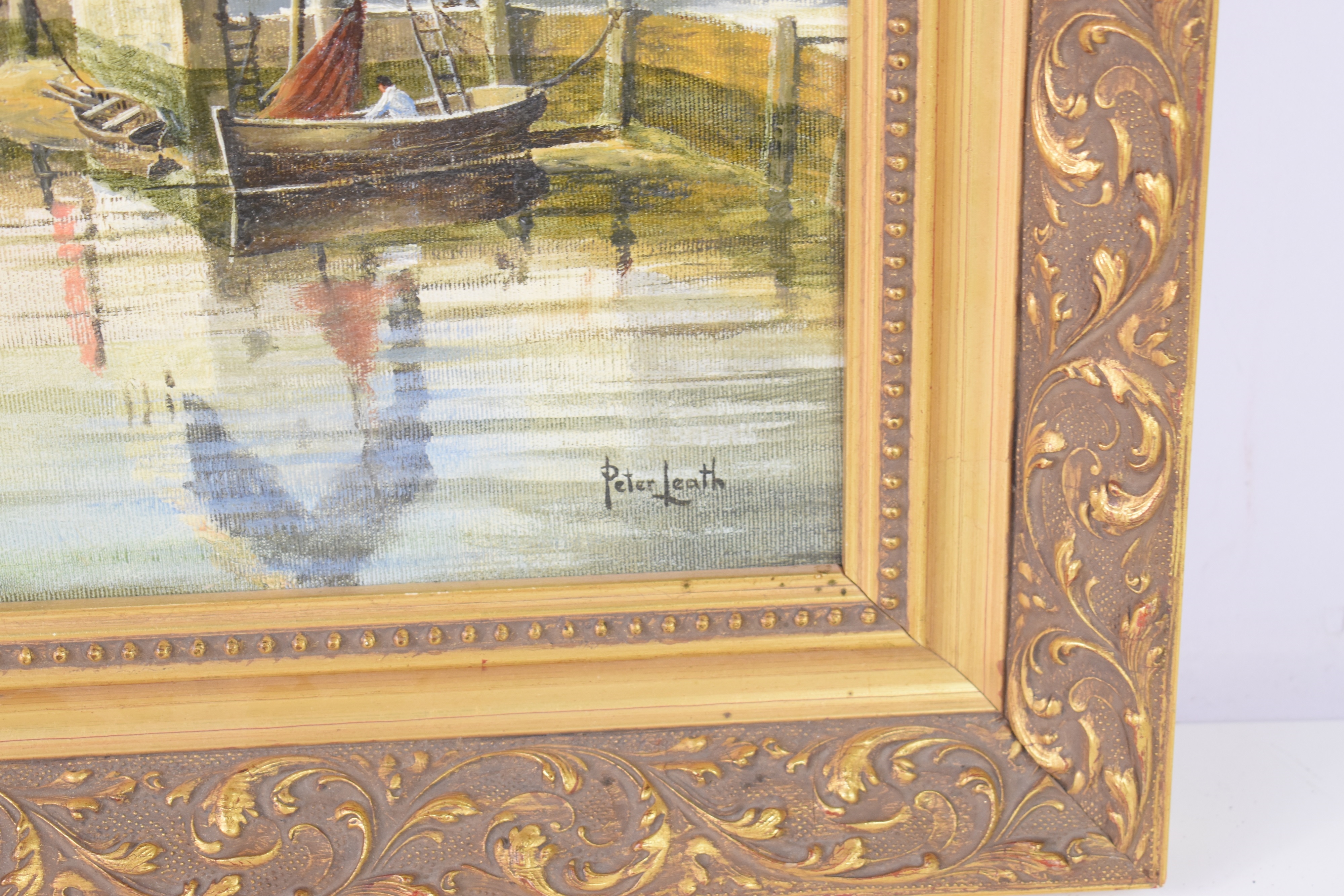 A serene harbor scene featuring boats, buildings, and calm water reflections.
