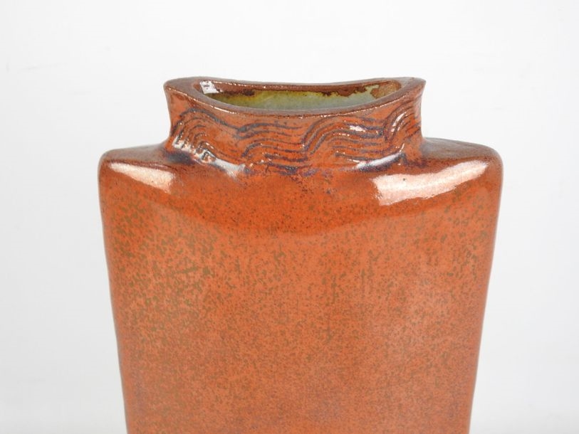 Artwork by Pierrette Soulet, Vase on pedestal with flattened body in orange glazed ceramic, Made of orange glazed ceramic