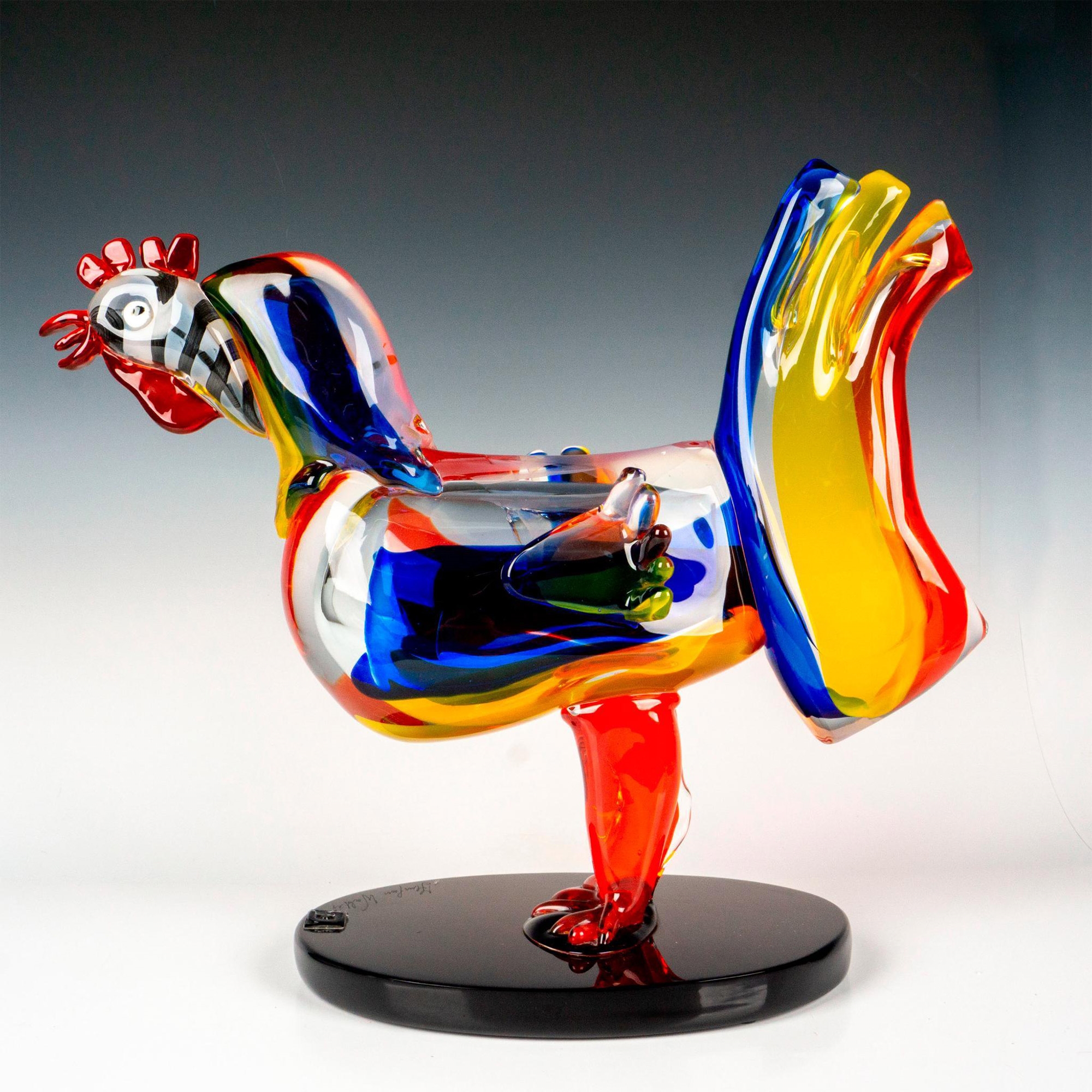A large colorful glass figure of rooster attached to a black glass base - Walter Furlan