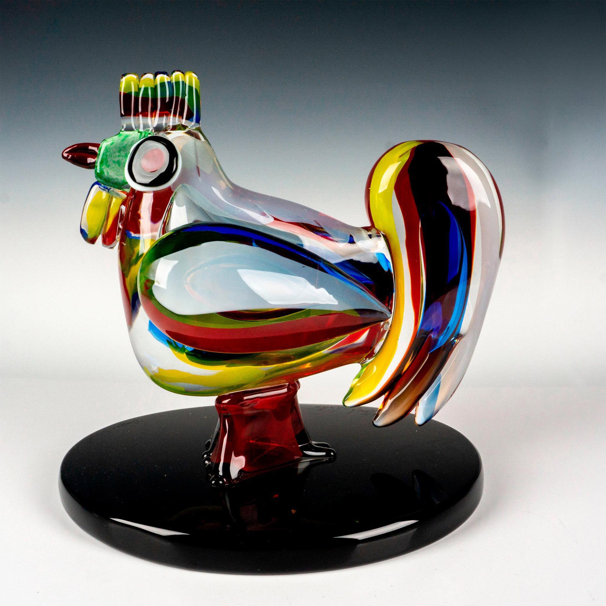 A large colorful glass figure of chicken attached to a black glass base - Walter Furlan