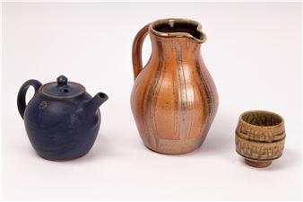 John Jelfs (born 1946) a stoneware jug with striped decoration on an orange background - John Jelfs