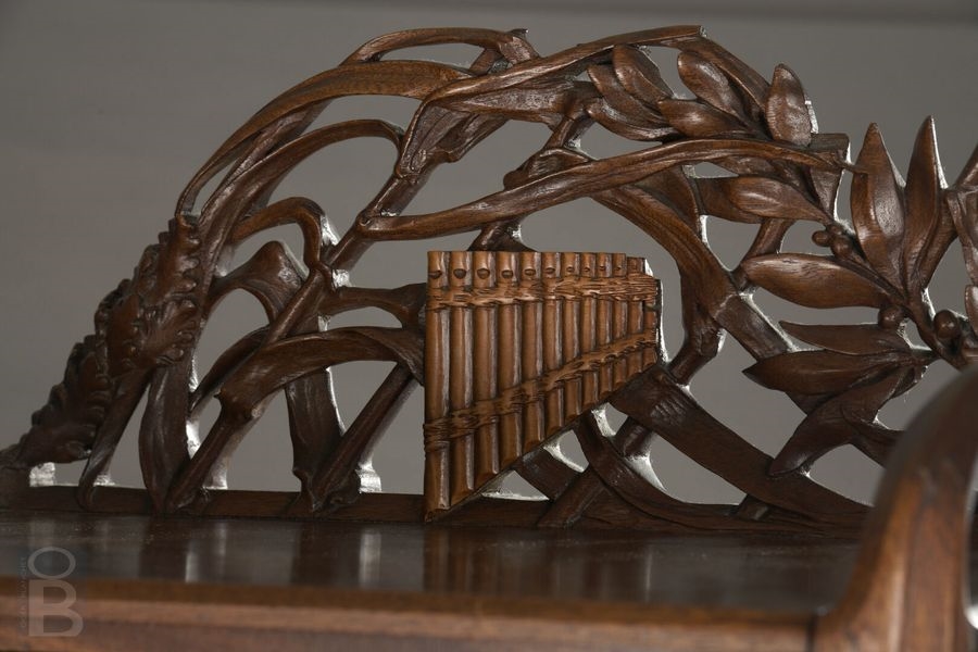 Artwork by René Defland, Score cabinet in  of two young women, Made of carved and molded cherry wood with orange wood decoration