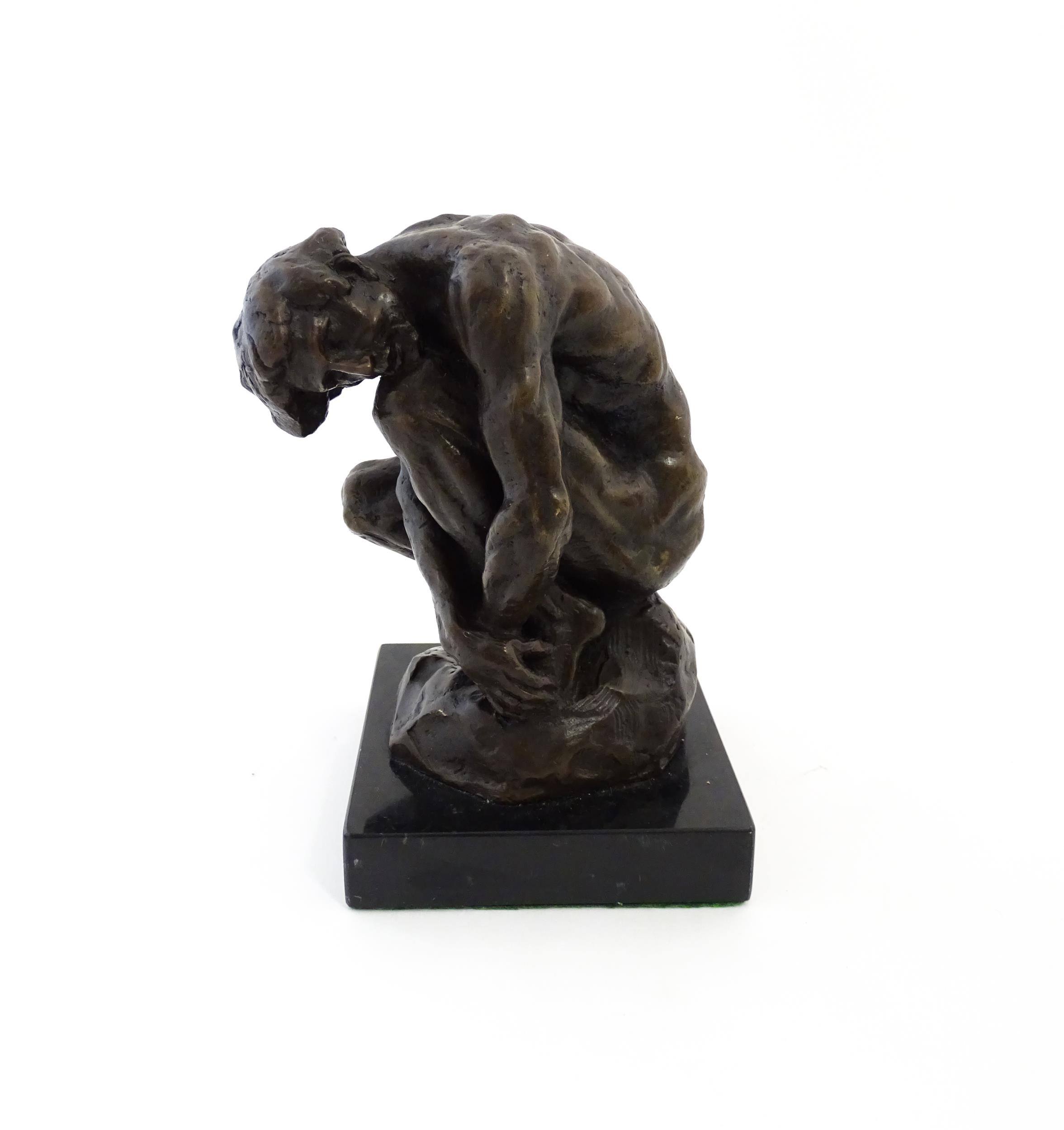 A thC cast bronze model of a crouching male nude. In the m - Auguste Rodin