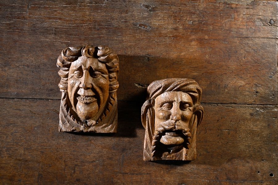 Pair of carved oak consoles depicting the heads of a man with a large moustache and a woman wearing a turban - French School, 17th Century