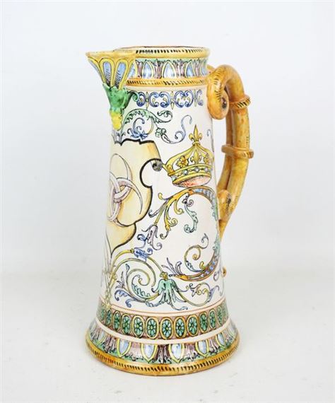 Polychrome earthenware double-handled pitcher, the white-bottomed body decorated with three moons entwined in a leatherette surrounded by crowned Cs by Ulysse Besnard, dated February 1878
