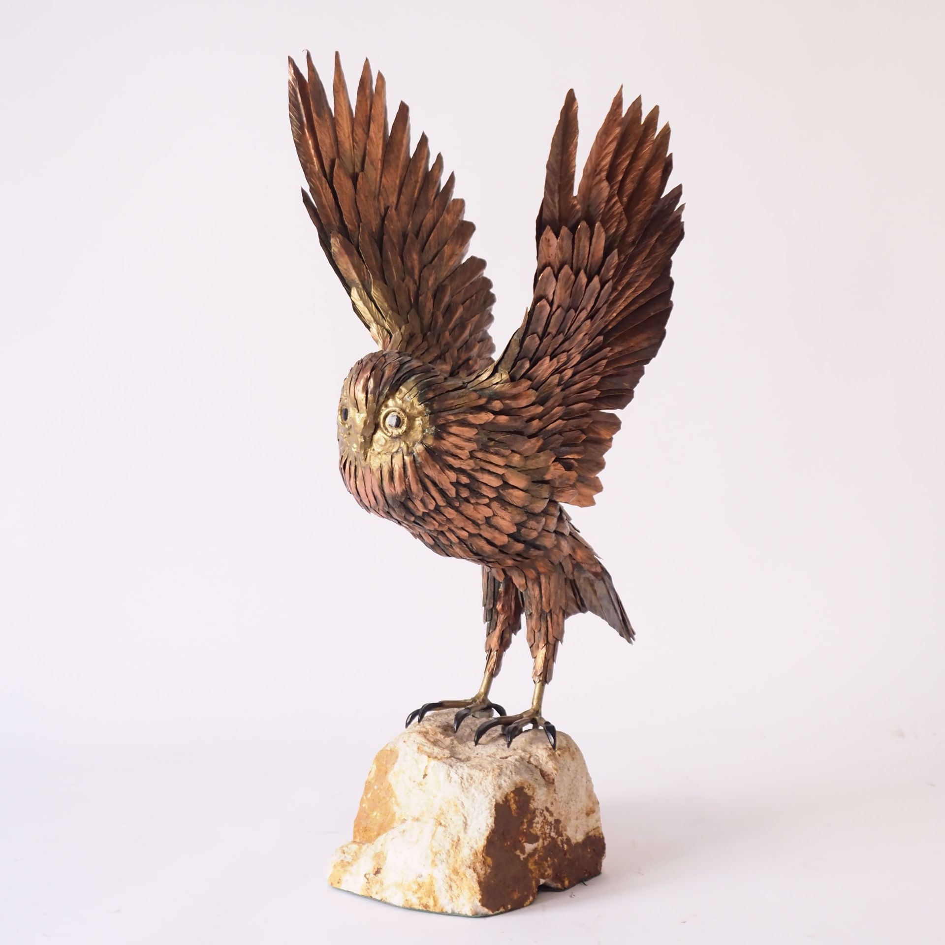 Artwork by Roger Pintens, Owl: metal sculpture on stone rock, Made of metal sculpture on stone