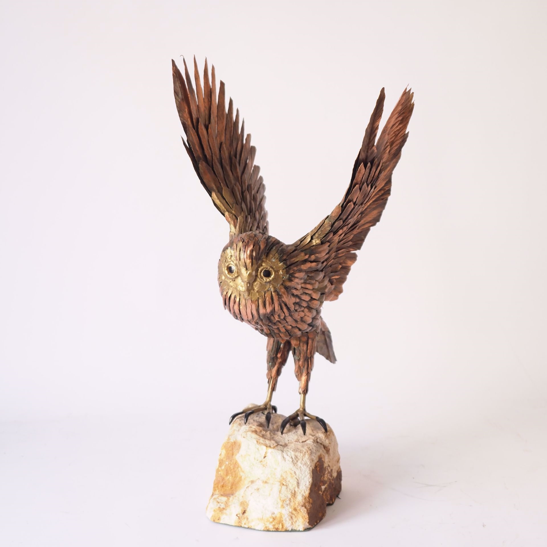 Artwork by Roger Pintens, Owl: metal sculpture on stone rock, Made of metal sculpture on stone
