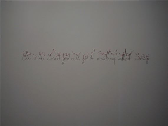 A minimalist composition featuring handwritten text on a plain background.