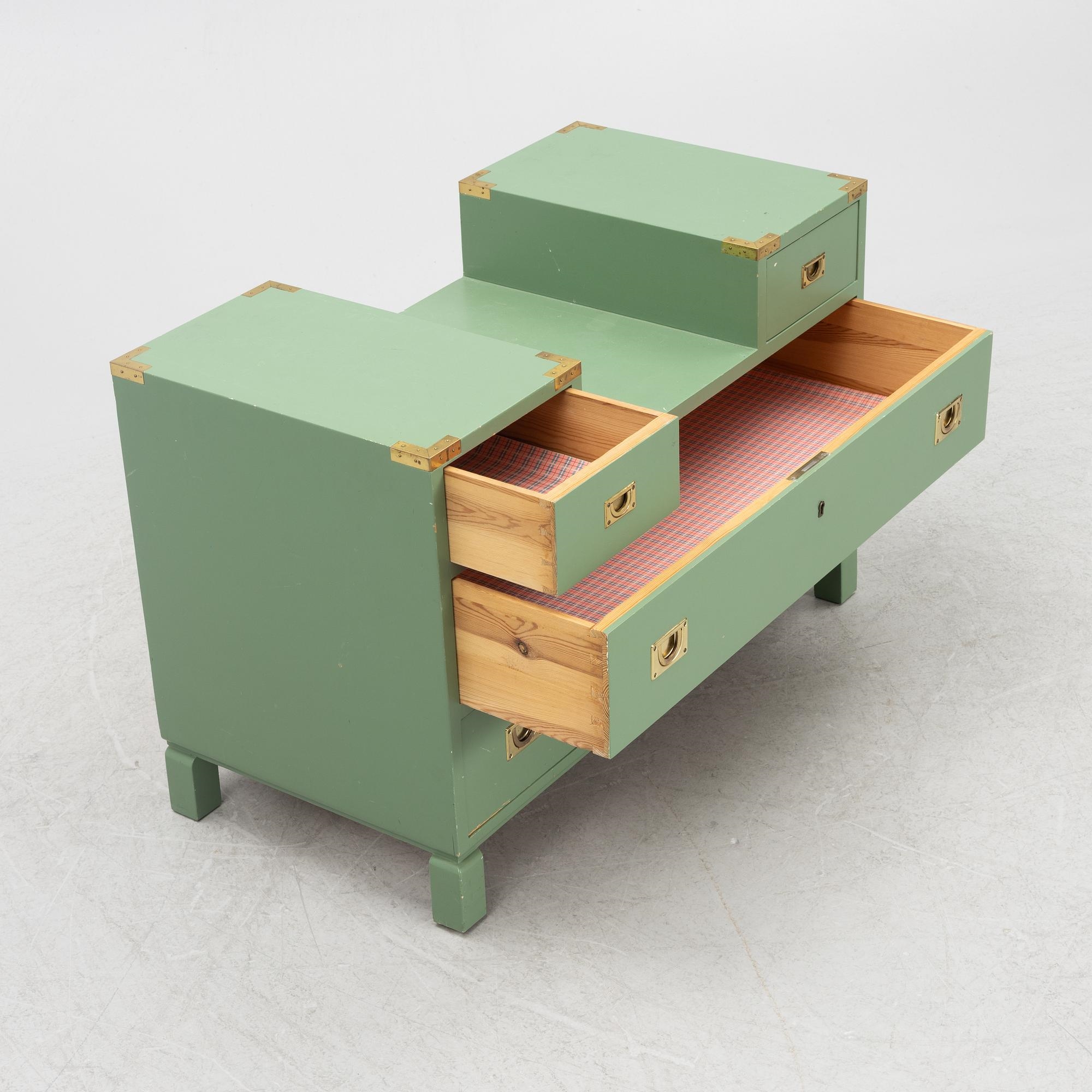 Artwork by Ove Feuk, Ove Feuk, a chest of drawers, Nordiska Kompaniet 1970s, Made of green lacquered with brass fittings