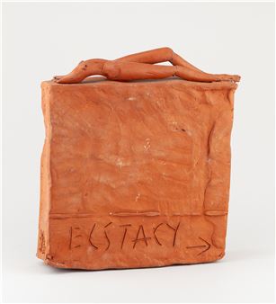 A terracotta sculpture featuring a reclining figure atop a block with the word 'ECSTASY' inscribed.