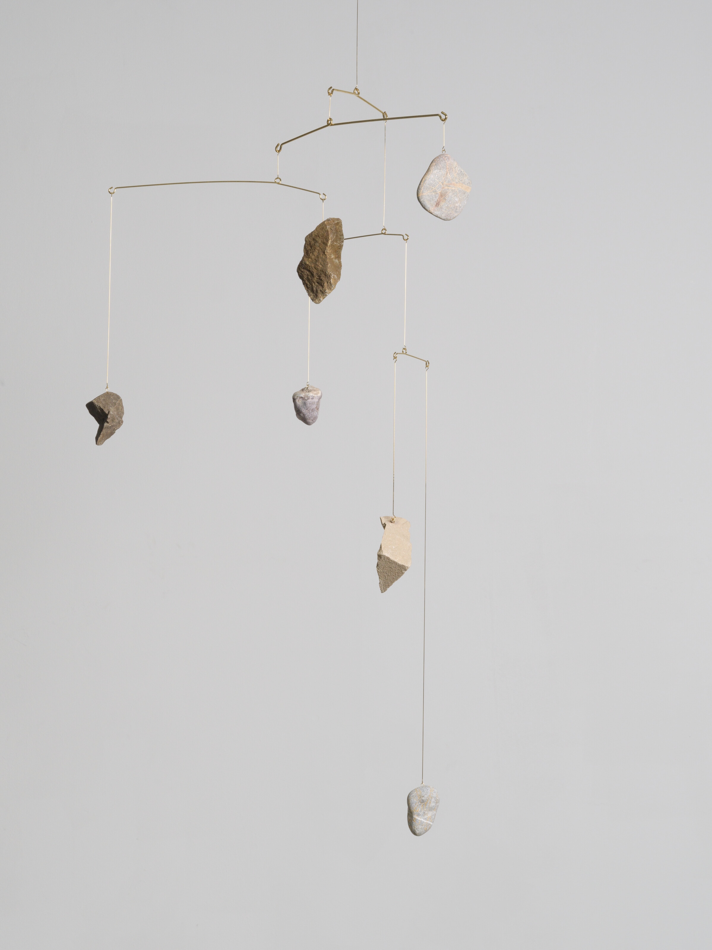 Artwork by Alicja Kwade, Rocking, Made of gold-plated steel and stones