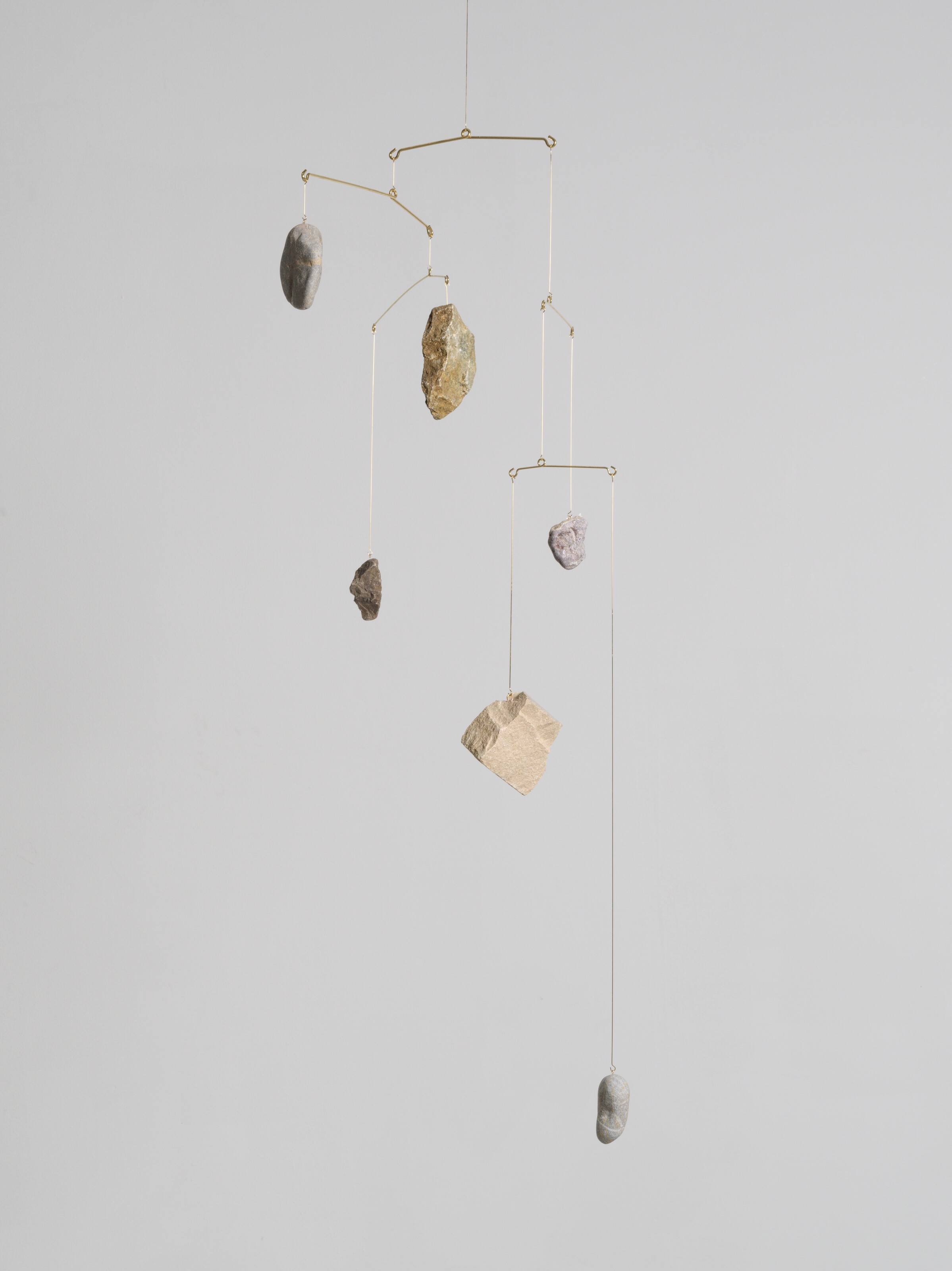 Artwork by Alicja Kwade, Rocking, Made of gold-plated steel and stones