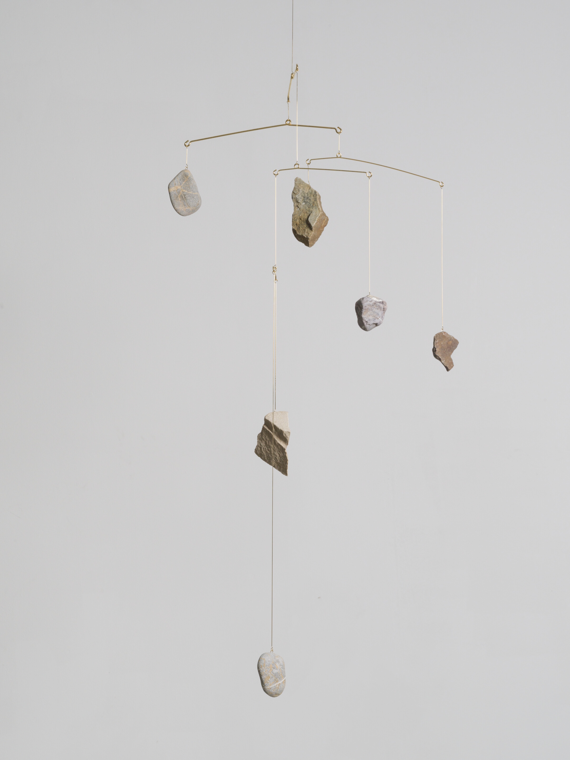 Artwork by Alicja Kwade, Rocking, Made of gold-plated steel and stones