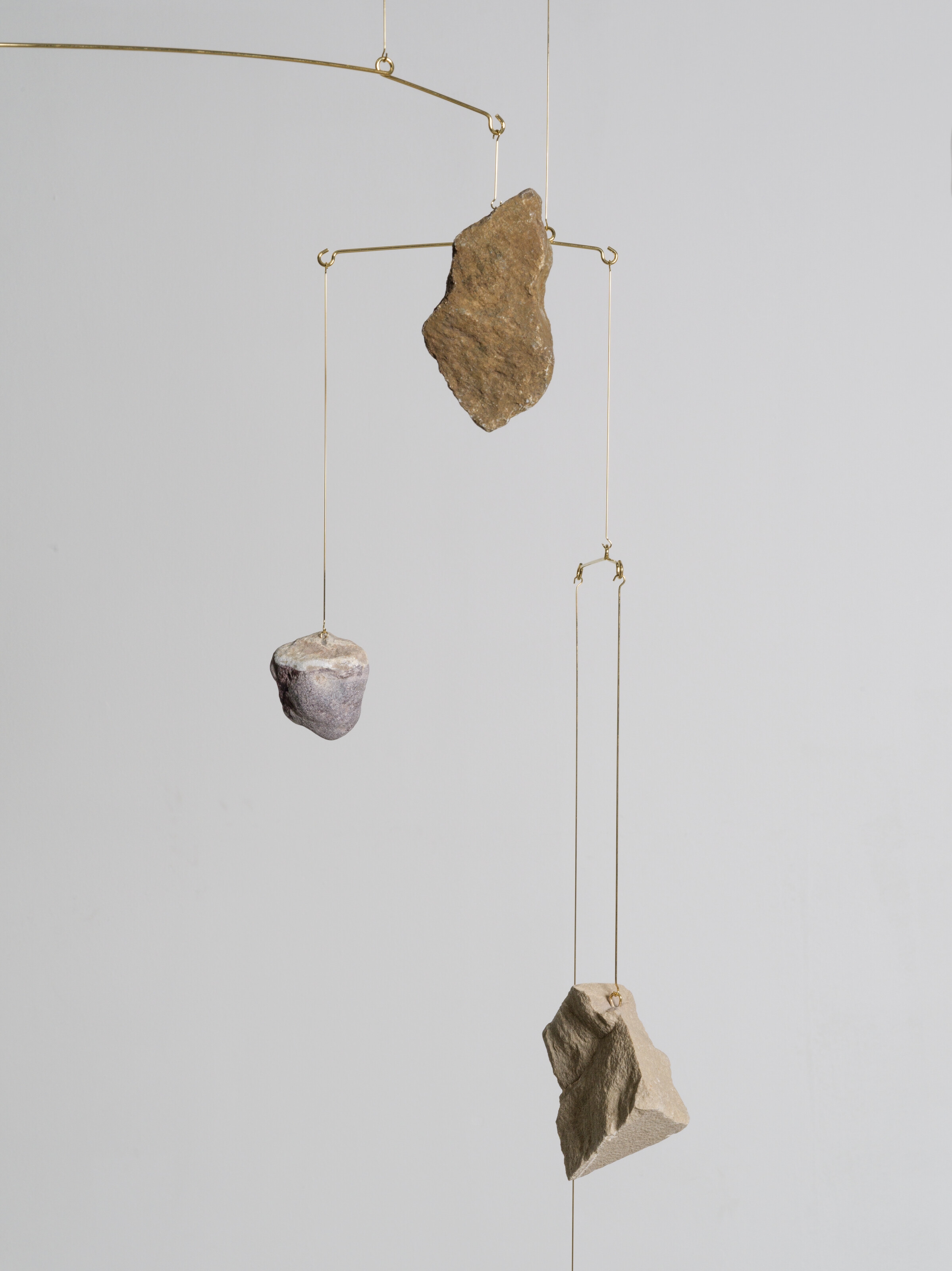 Artwork by Alicja Kwade, Rocking, Made of gold-plated steel and stones