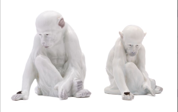 Artwork by Gebruder Heubach, figures of a seated monkey observing a fly on the back of its hand, Made of porcelain