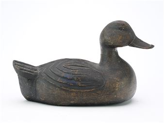 Black duck with slightly turned head and deep relief feather carving - Bill Cooper