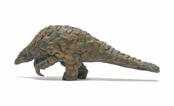 Artwork by Robert Rorich, Pangolin Boy, Made of bronze with a brown patina