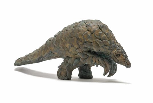 Artwork by Robert Rorich, Pangolin Boy, Made of bronze with a brown patina